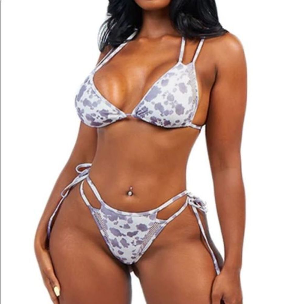 Cow print bikini featuring thin straps and‎ mesh inserts.